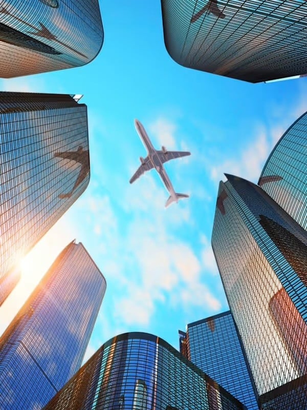 Airplane flying over buildings